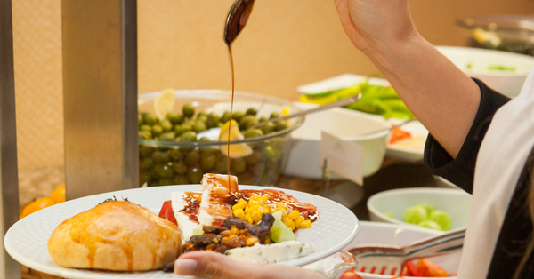 Woman preparing delicious meal in a kitchen . side view.